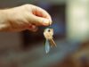 A hand holding keys to a home