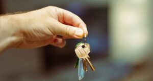 A hand holding keys to a home