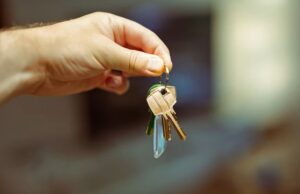 A hand holding keys to a home