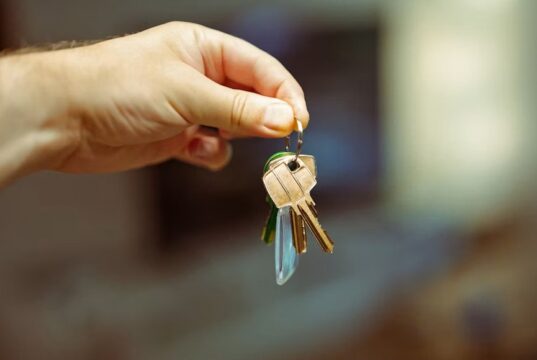 A hand holding keys to a home